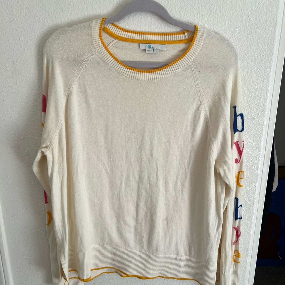 Boden Cream Sweater with Colorful Sleeve Lettering
Has a few  stains